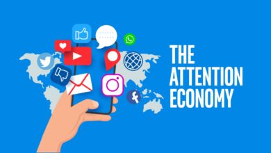 Hand holding a smartphone with floating social media icons